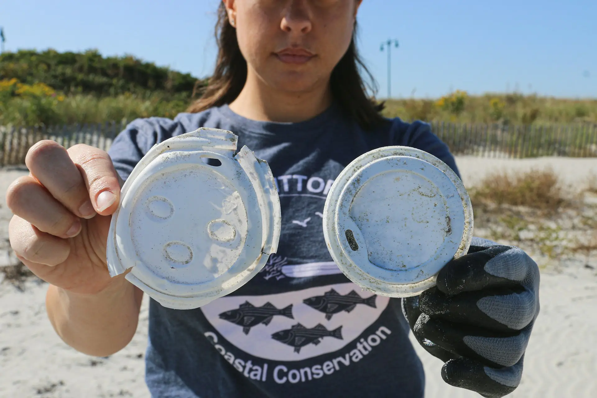 young-woman-holding-plastic-lids