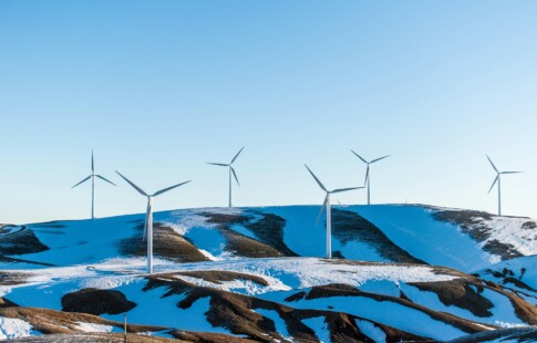 wind turbines on a snowy hill