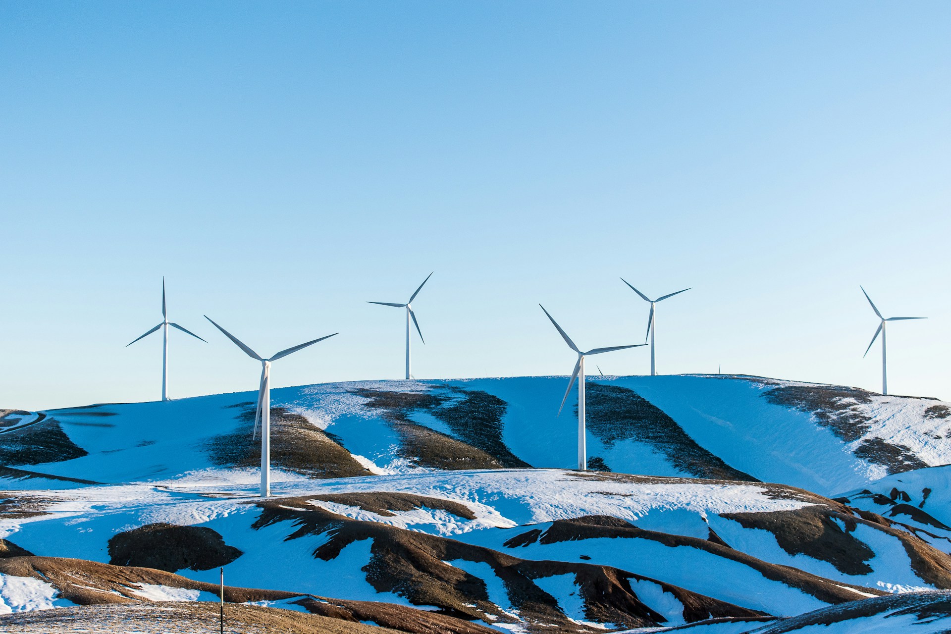 wind turbines on a snowy hill