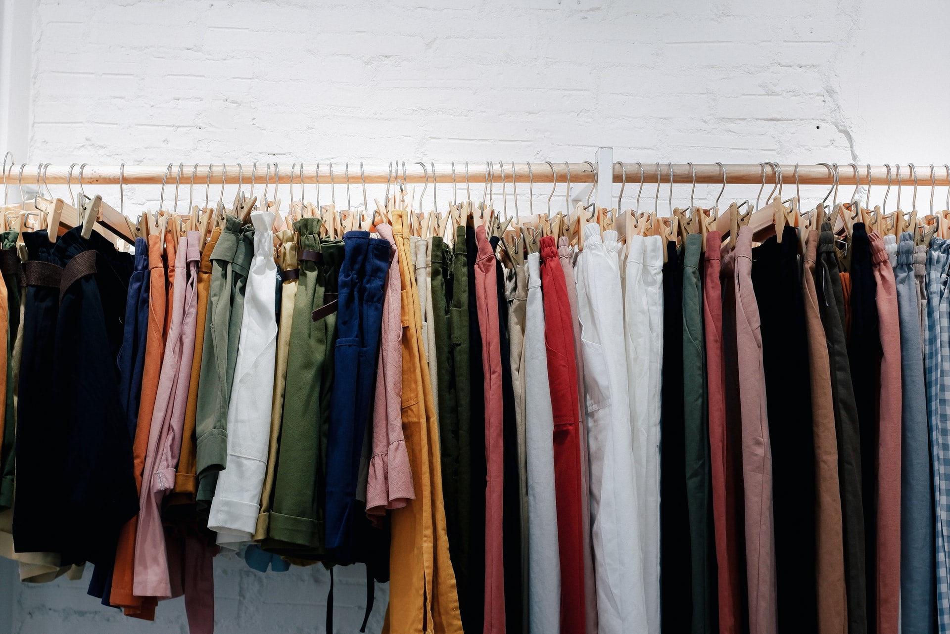 a sustainable wardrobe handing on a clothing rack