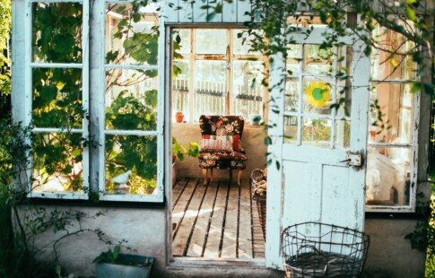 sunroom with floral chair and greenery