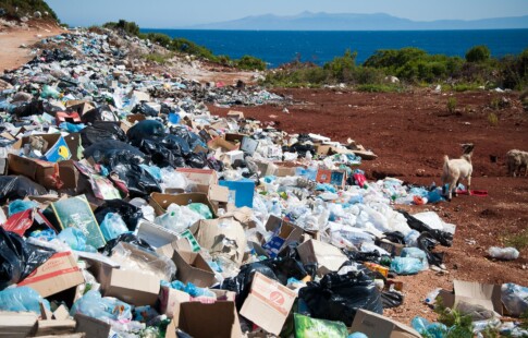A beach covered in trash from consumerism