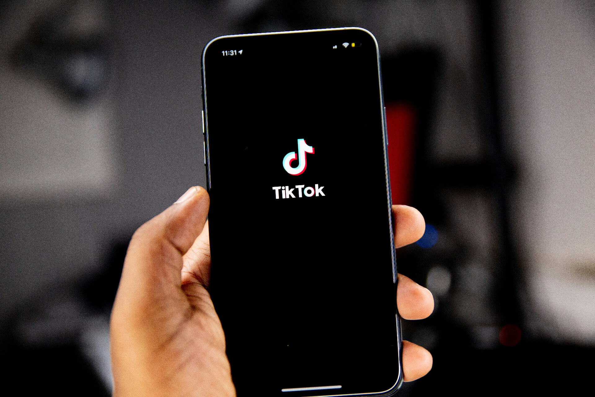 person holding phone with tiktok app up