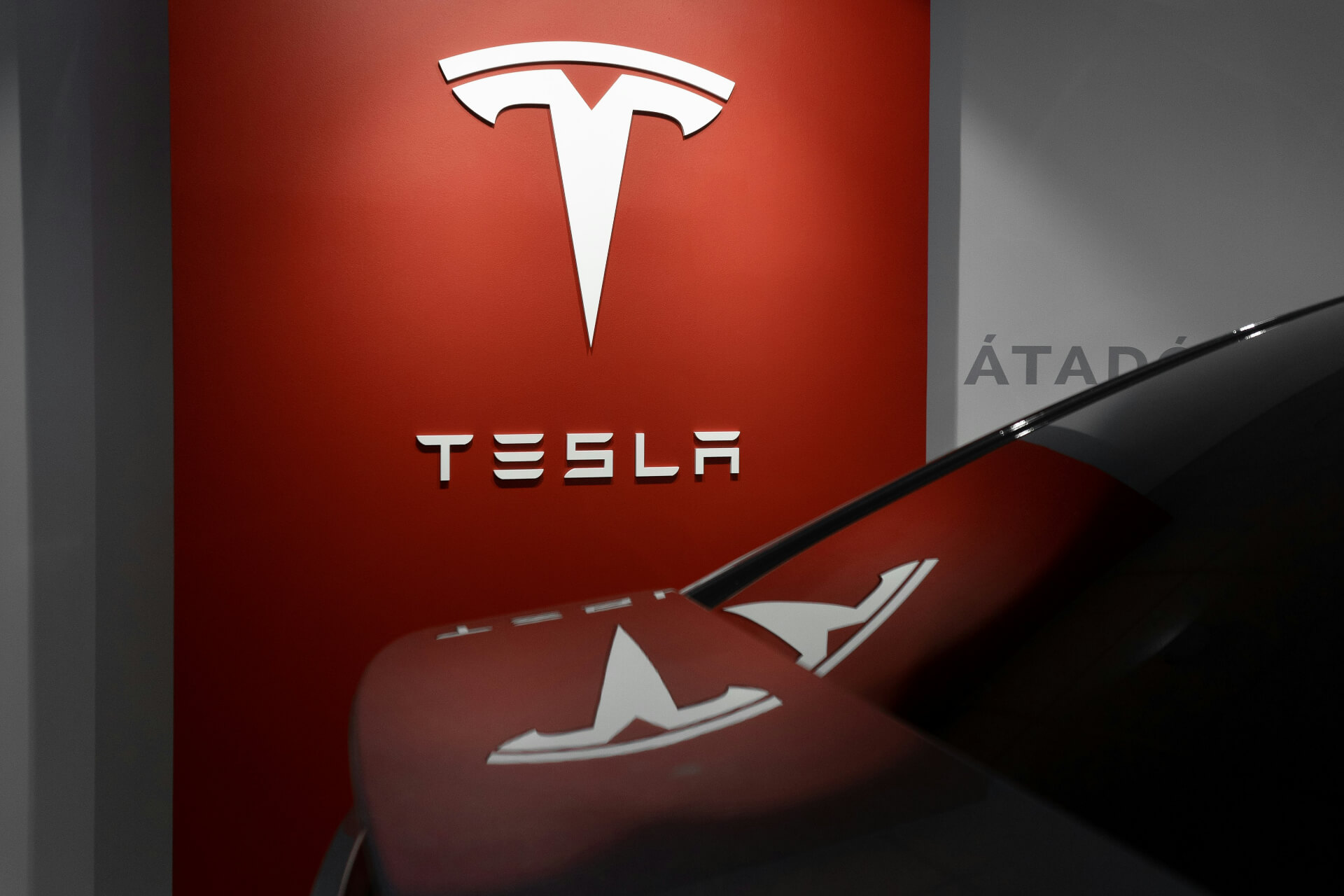 Tesla logo above Tesla car
