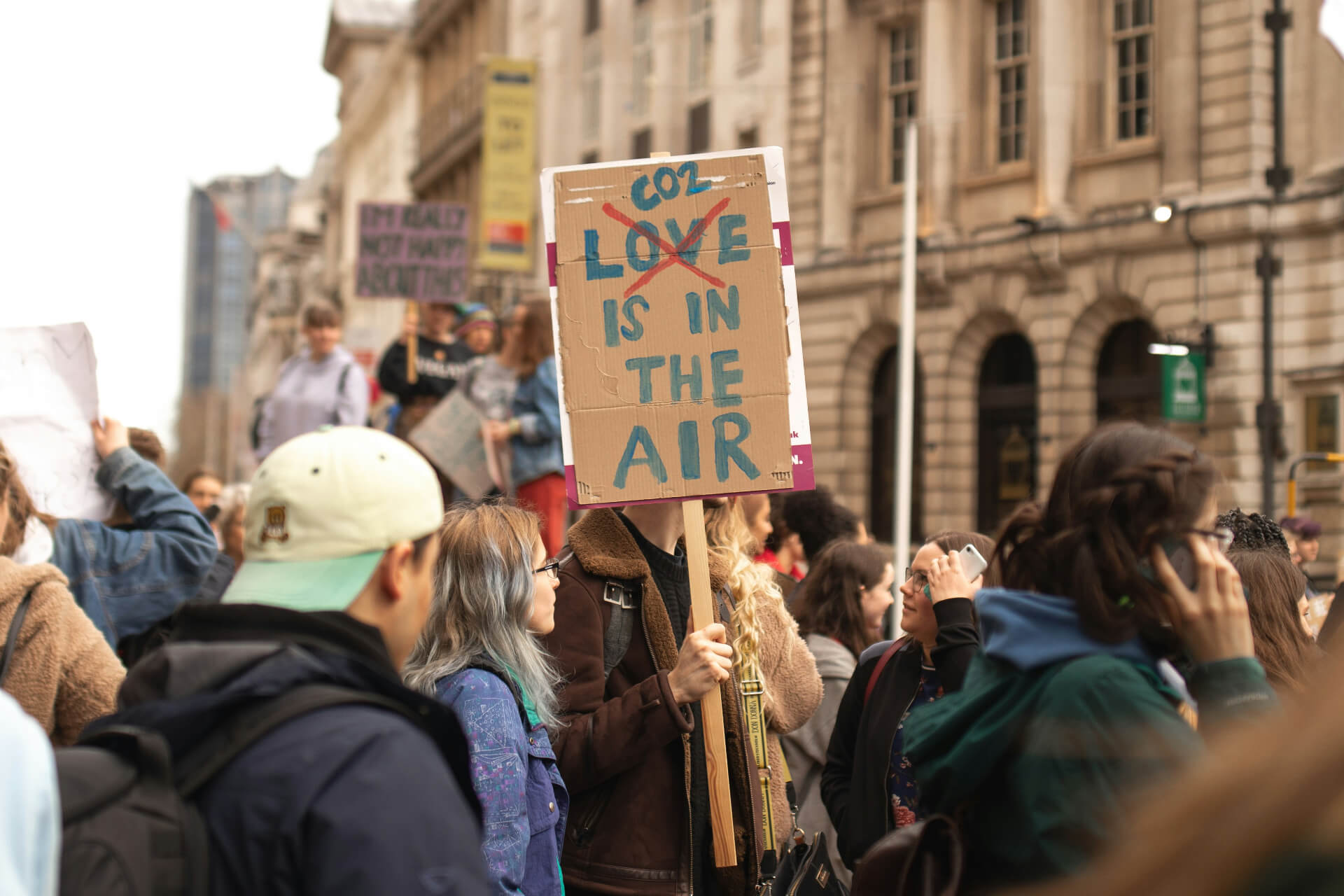 sign that reads co2 is in the air with love crossed out