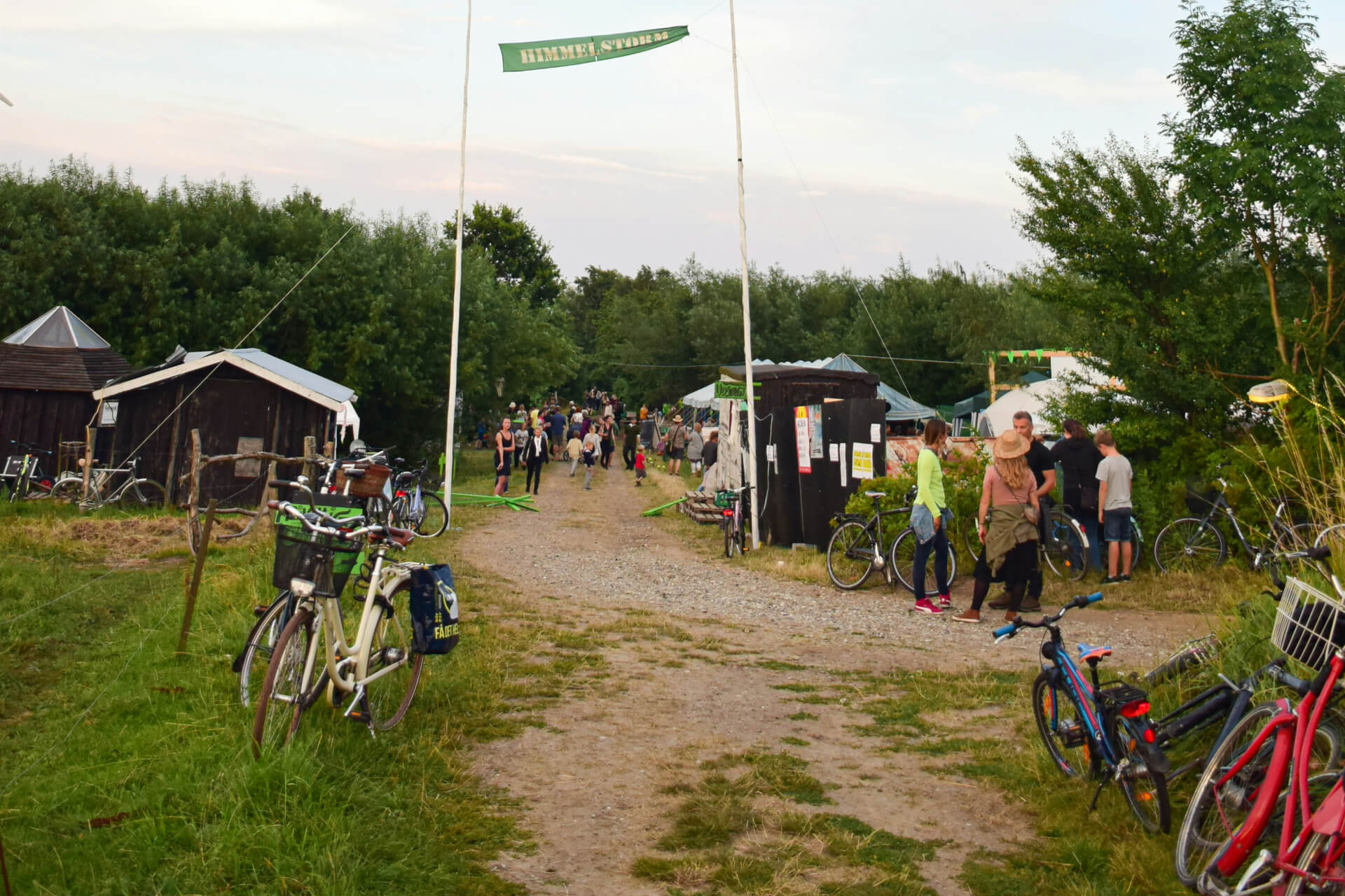 group of people standing next to dirt road himmelstorm festival dyssekilde