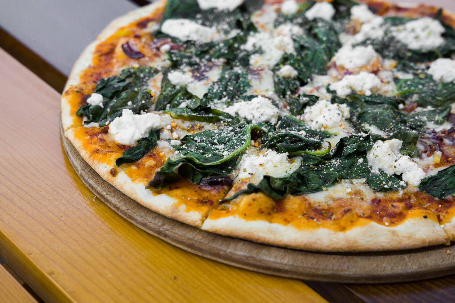 close up of vegan pizza with greens