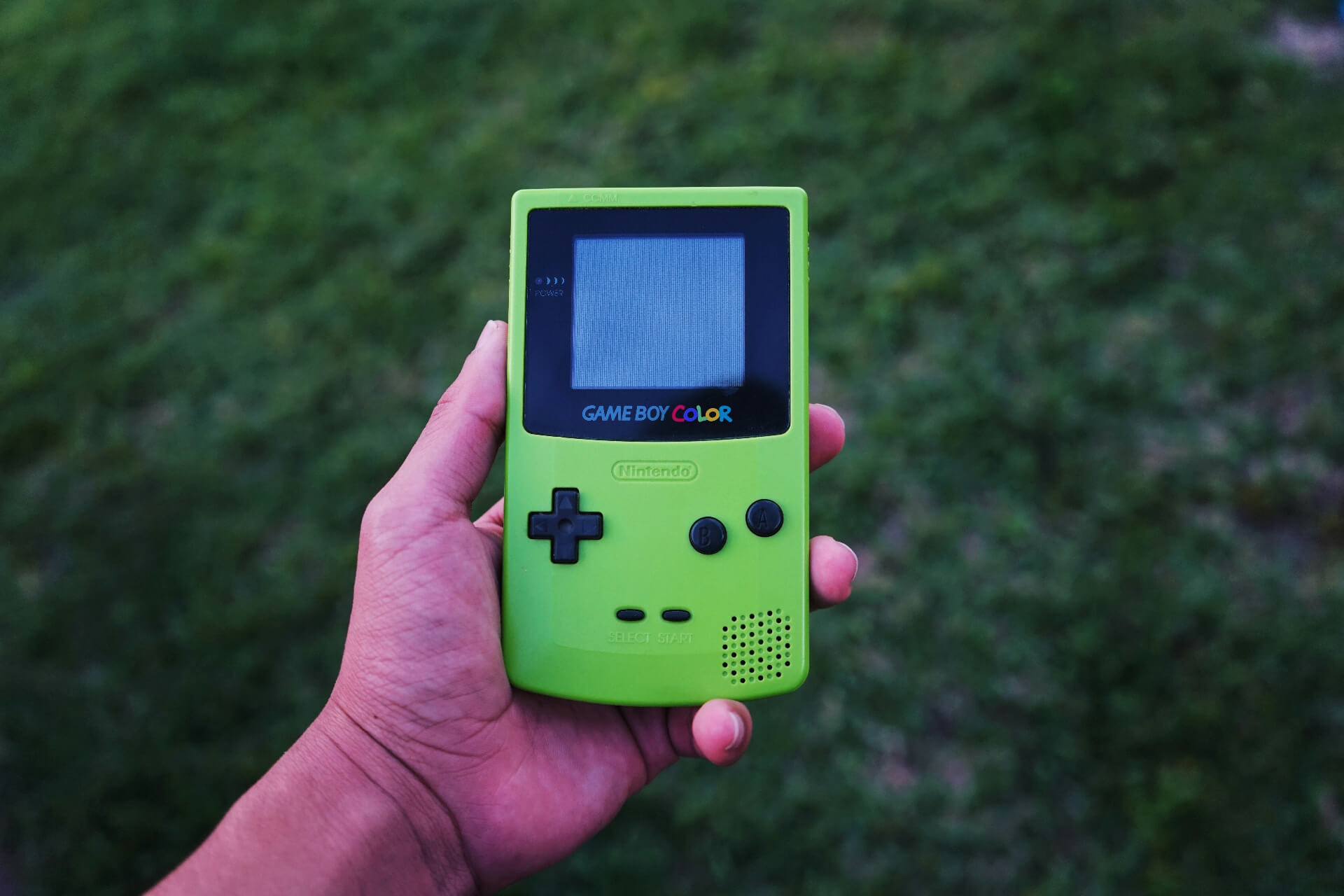 person holding a green game boy