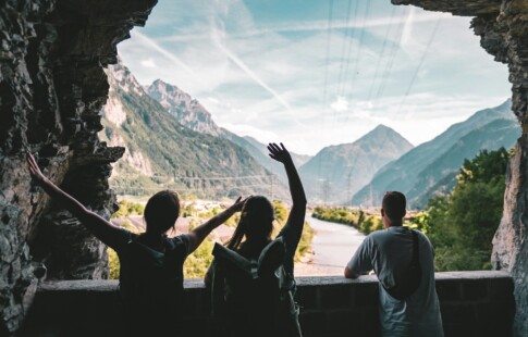 Three tourists looking at mountains