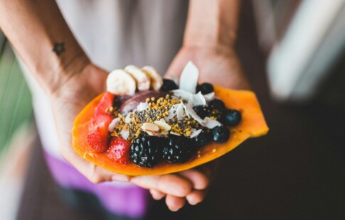 Fruit and granola in the center of a papaya