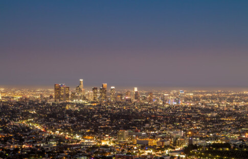 A shining city skyline at night. There are no stars in the sky.