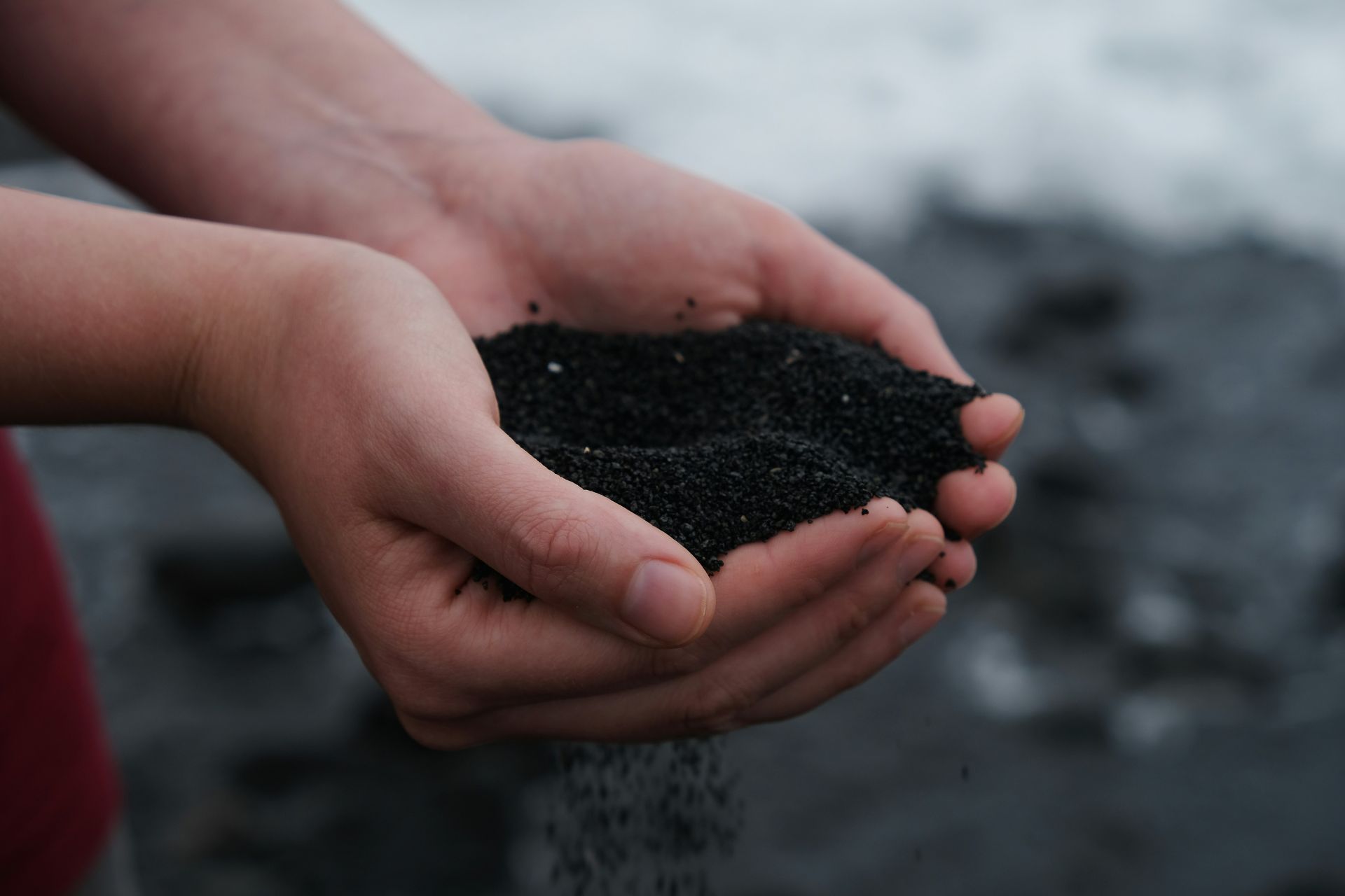 A person holding a fresh pile of soil